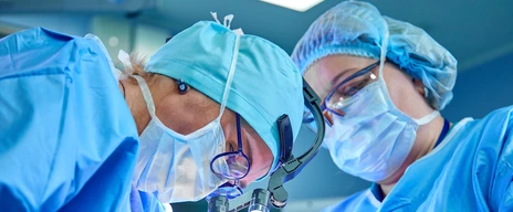 A surgeon&#39;s team in uniform performs an operation on a patient at a cardiac surgery clinic. Modern medicine, a professional team of surgeons, health.