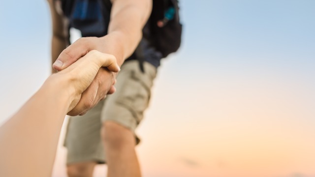 people in BayWa r.e. high is vests walking on a path