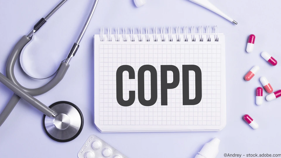 The word copd written on a white notepad on a blue background near a stethoscope, syringe, electronic thermometer and pills. Medical concept