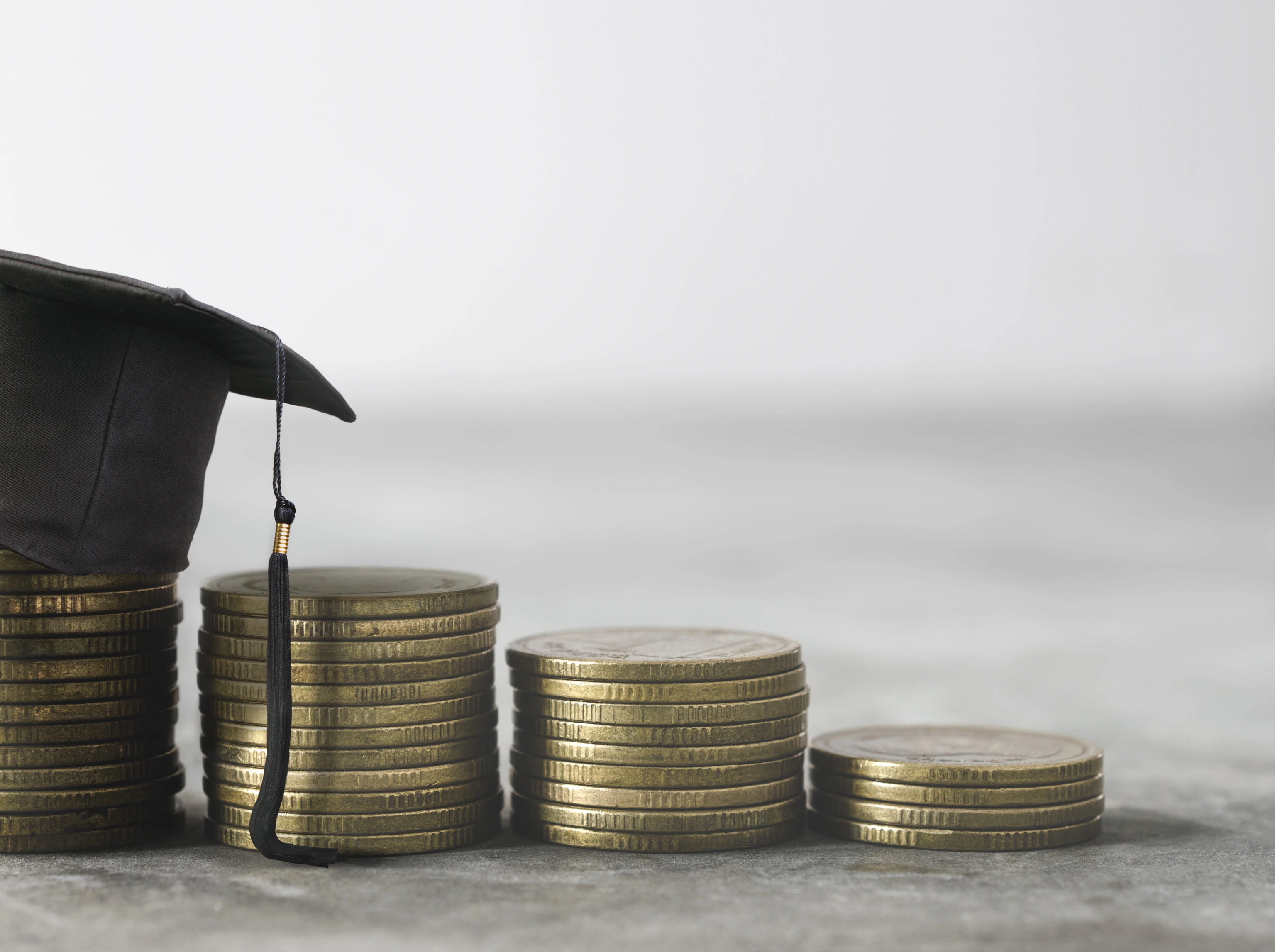 congratulations graduates on top of the money scholarship money background concept.