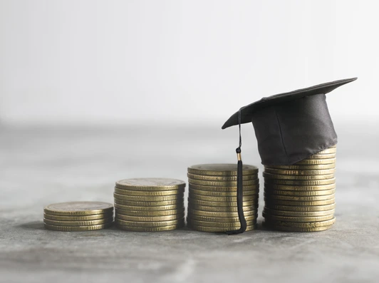 congratulations graduates on top of the money scholarship money background concept.