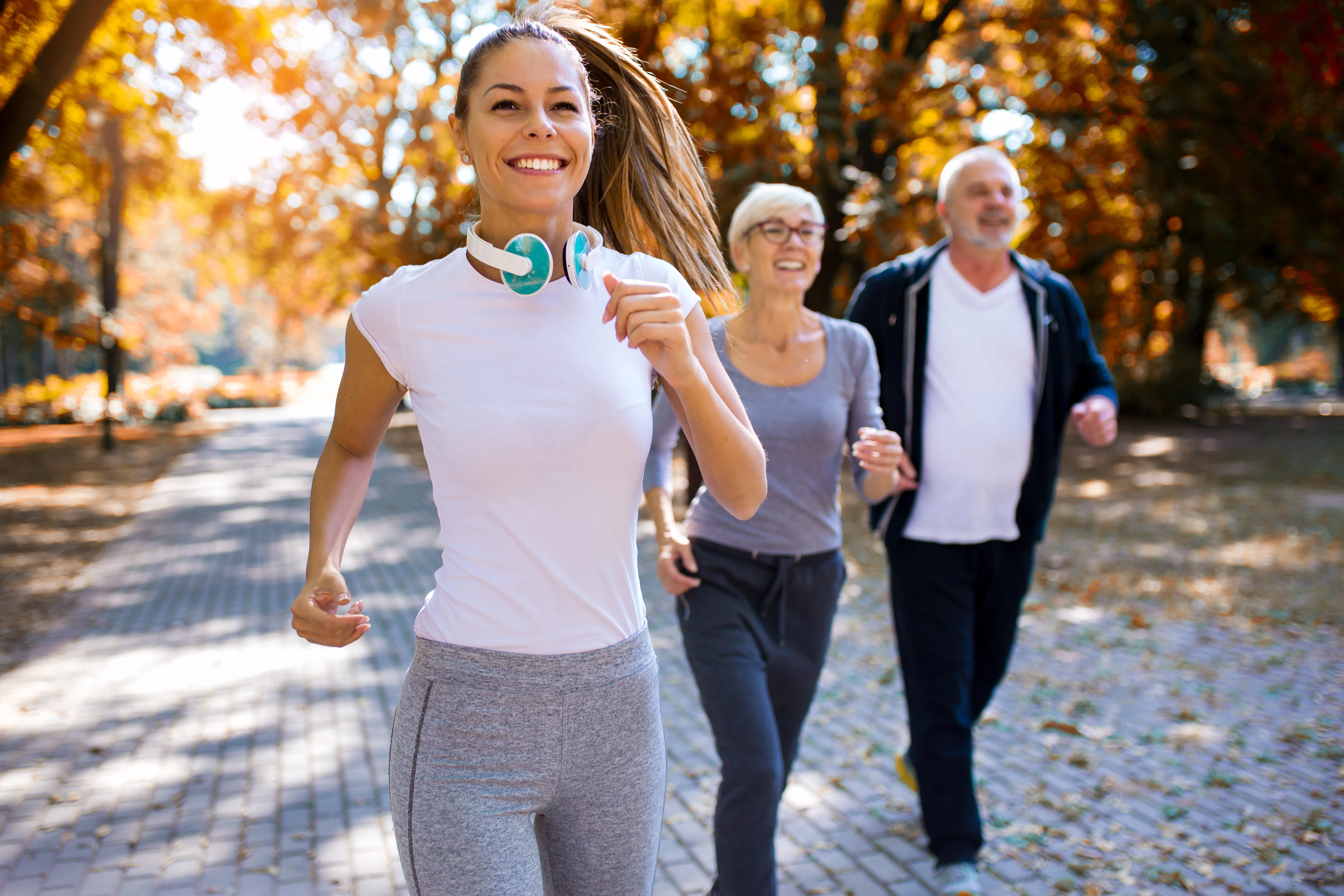Coach running with old couple