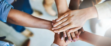 Together we can do great things. Cropped shot of a group of businesspeople piling their hands on top of each other.