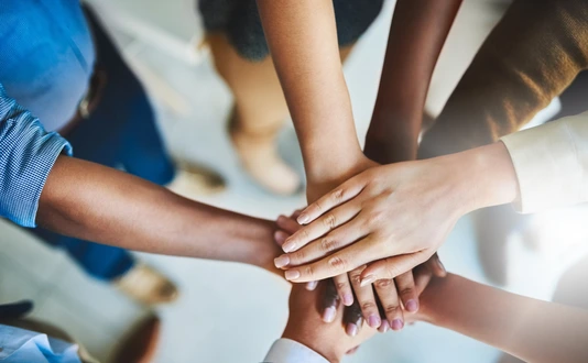 Together we can do great things. Cropped shot of a group of businesspeople piling their hands on top of each other.