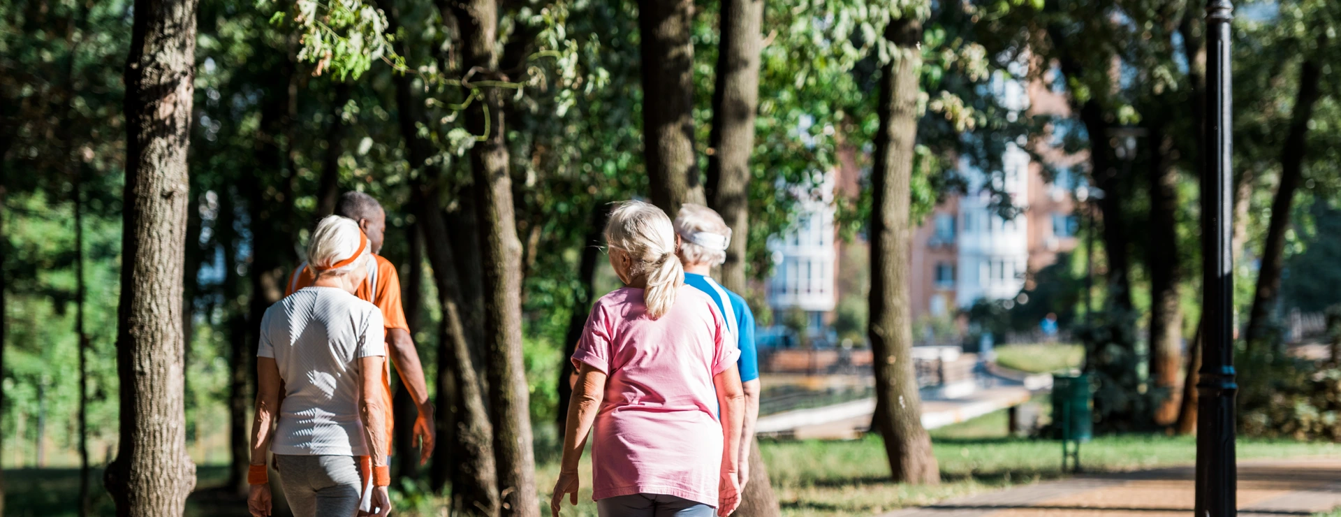 back view of senior women running near multicultural retired men