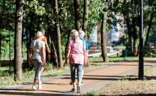 back view of senior women running near multicultural retired men