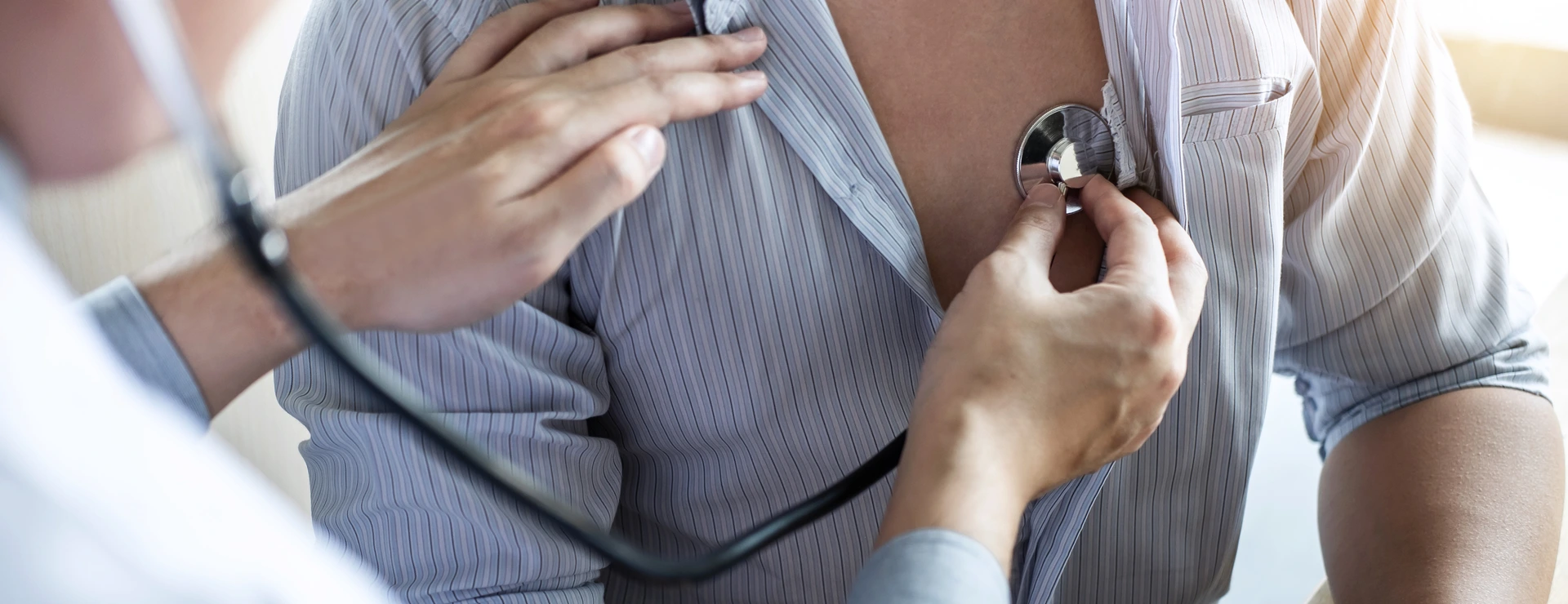 Doctor using a stethoscope checking patient