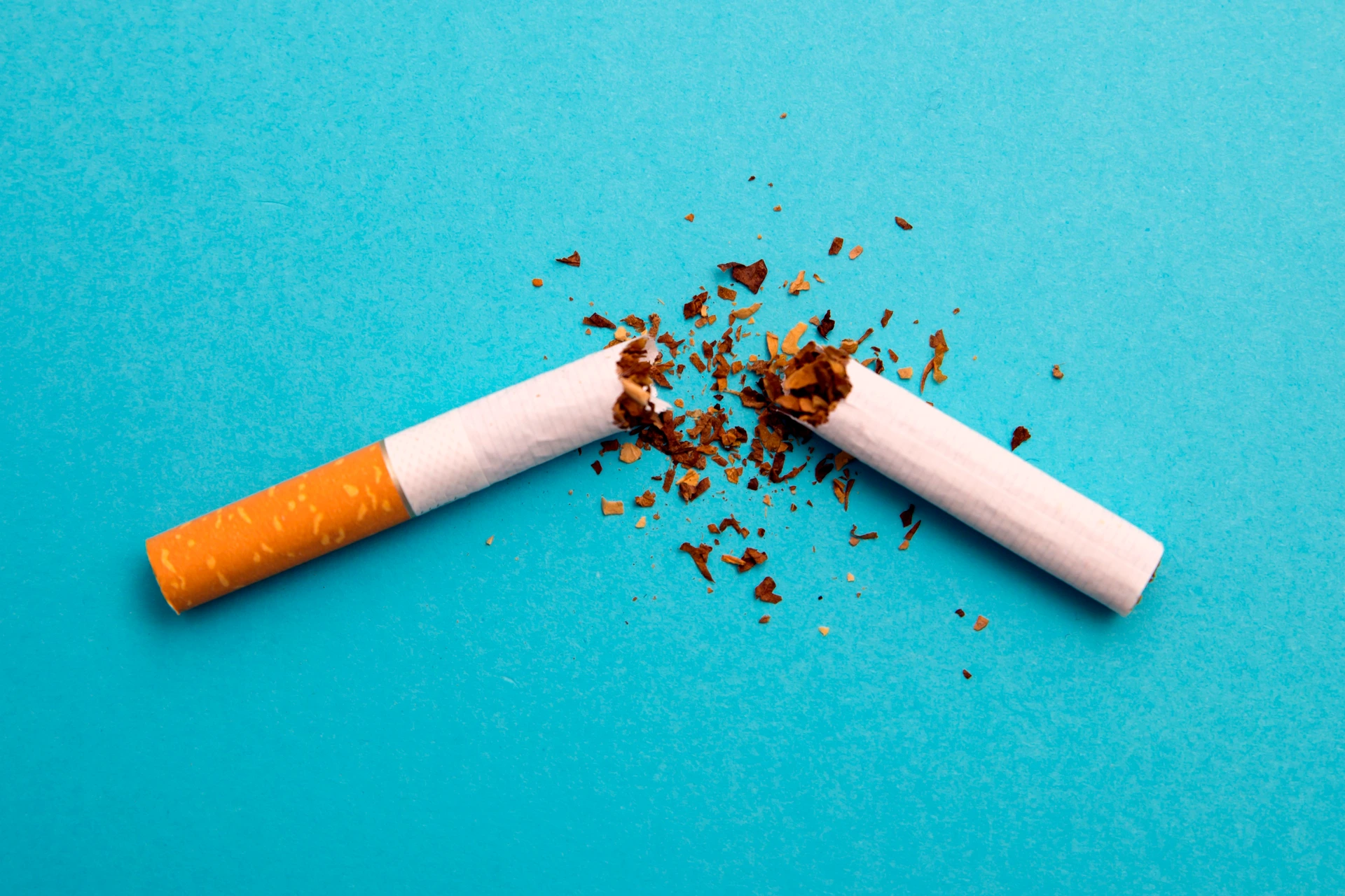 broken cigarette on a blue background