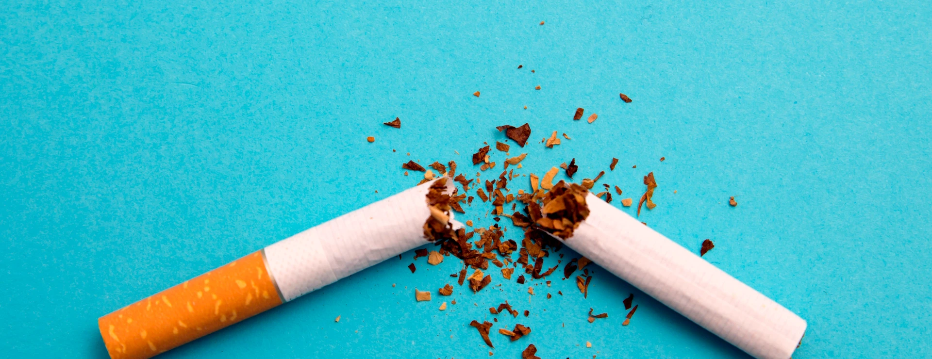 broken cigarette on a blue background