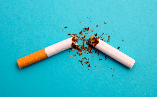 broken cigarette on a blue background