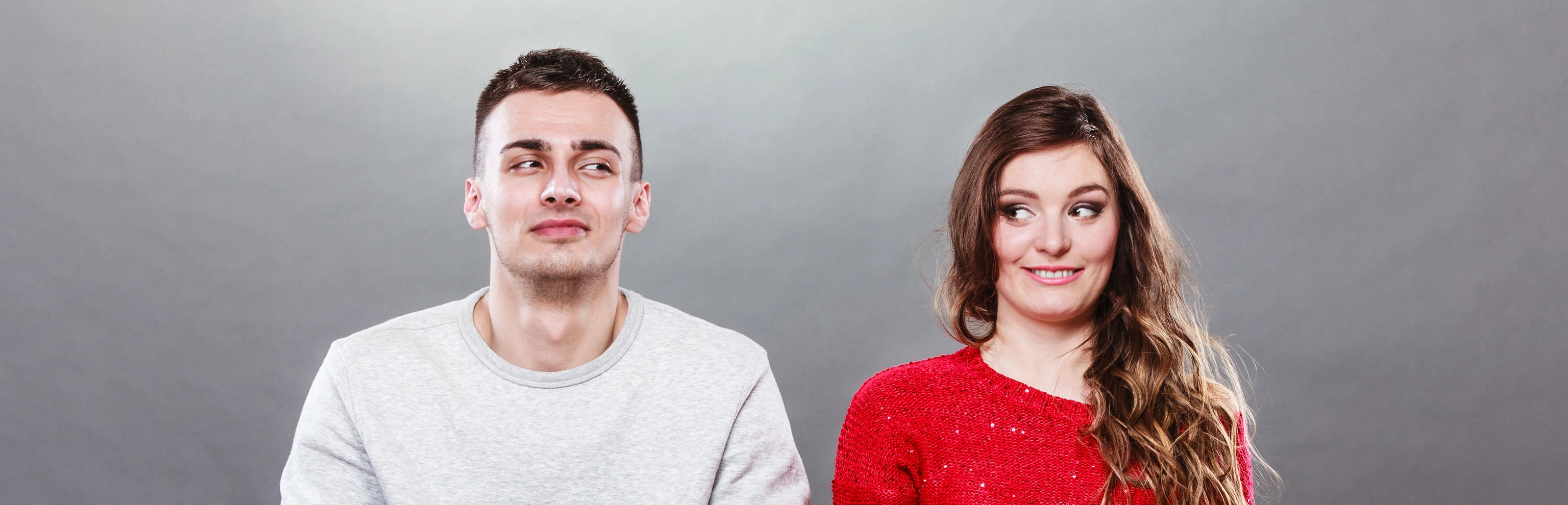 Shy woman and man sitting on sofa. First date.