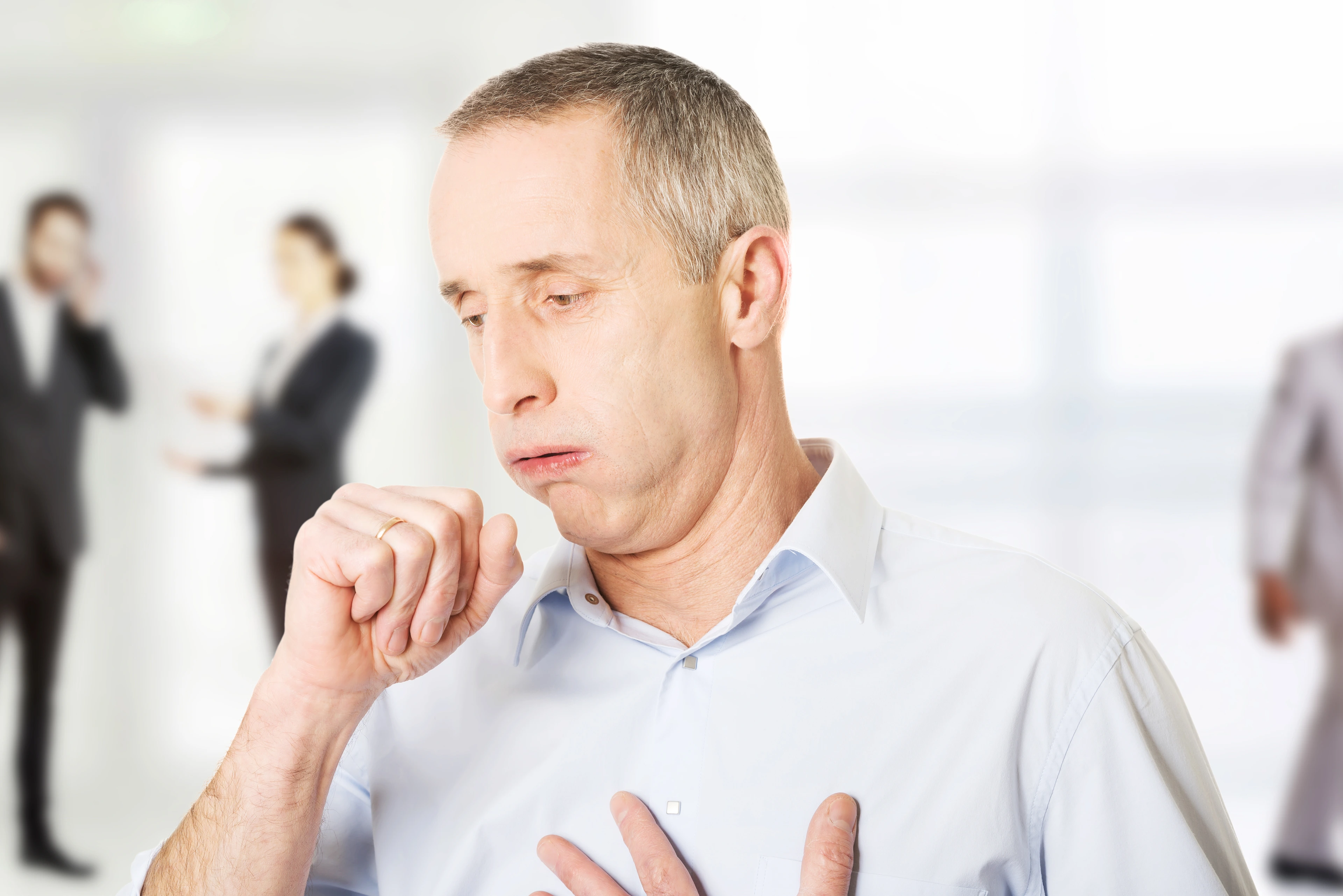Mature man coughing.
