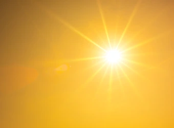 Summer background, orange sky with glowing sun