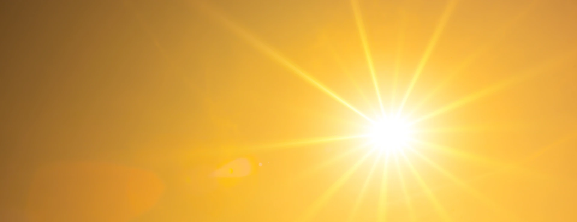 Summer background, orange sky with glowing sun
