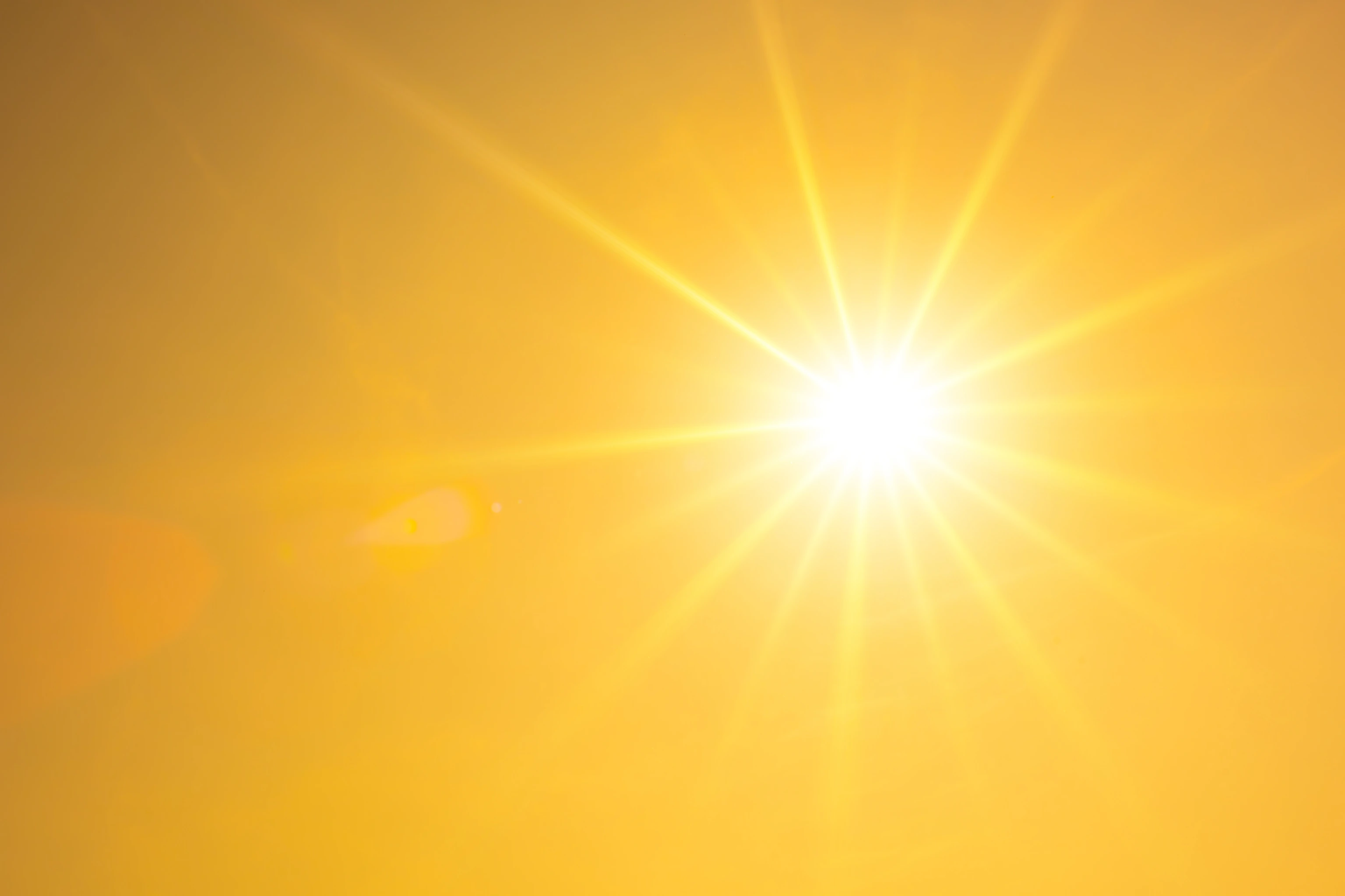 Summer background, orange sky with glowing sun