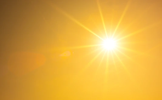 Summer background, orange sky with glowing sun