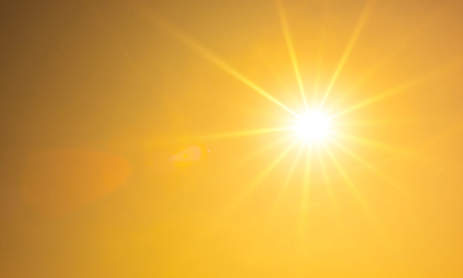 Summer background, orange sky with glowing sun