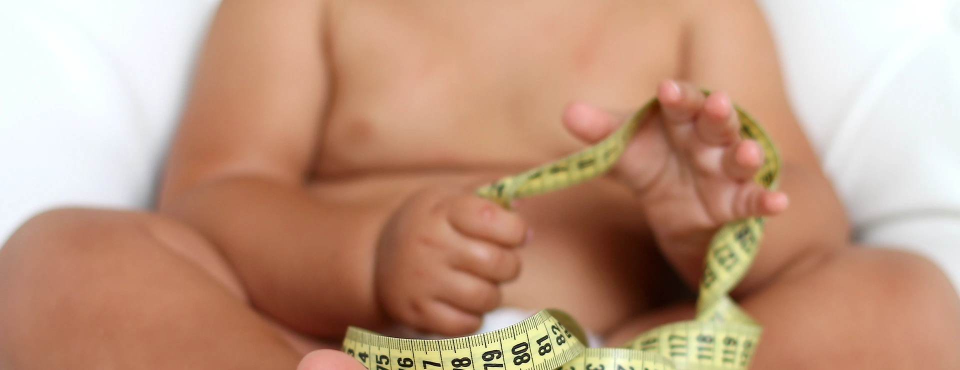 Adorable Baby Boy with a measuring tape