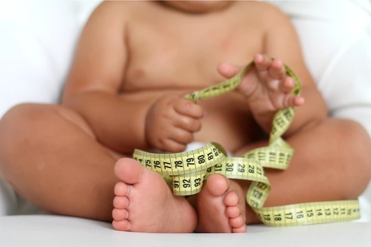 Adorable Baby Boy with a measuring tape