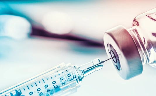 Close-up medical syringe with a vaccine.
