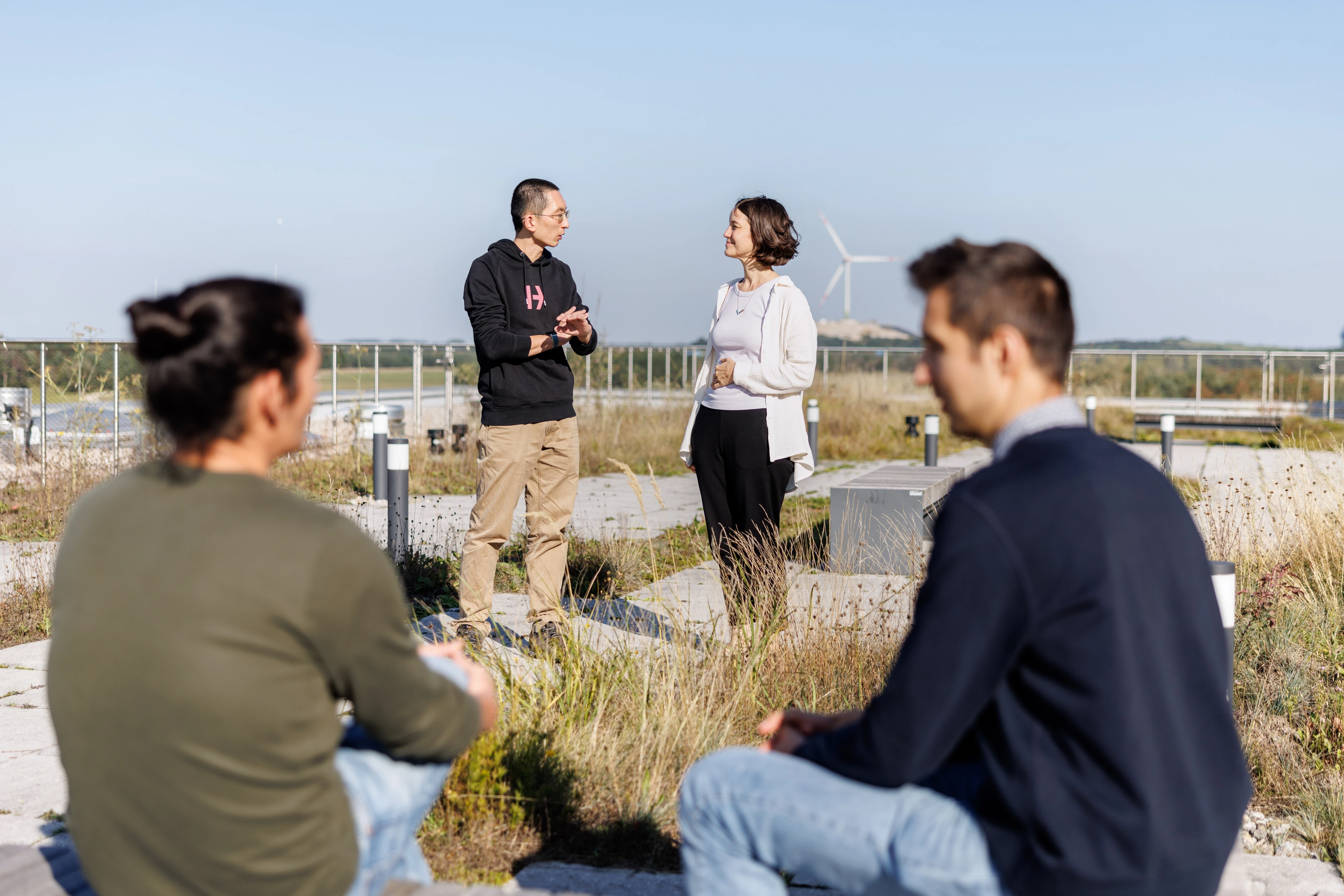 Employees in conversation on the HDC rooftop terrace