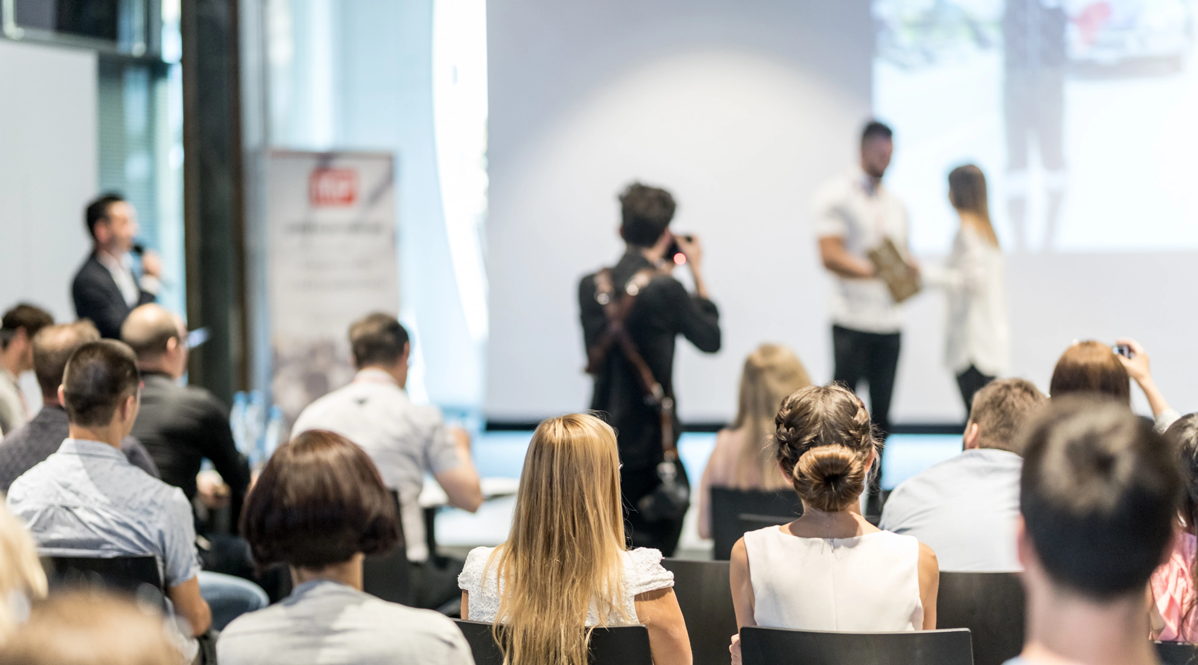 Young business team receiving award at best business project competition event.