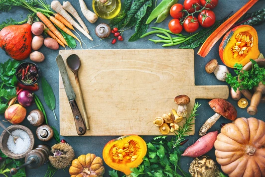 Healthy or vegetarian nutrition concept with selection of organic autumn fruits and vegetables on rustic wooden table