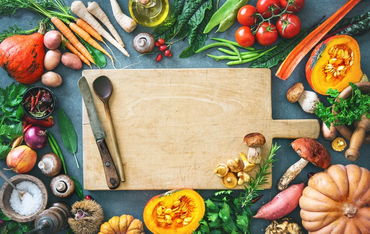Healthy or vegetarian nutrition concept with selection of organic autumn fruits and vegetables on rustic wooden table