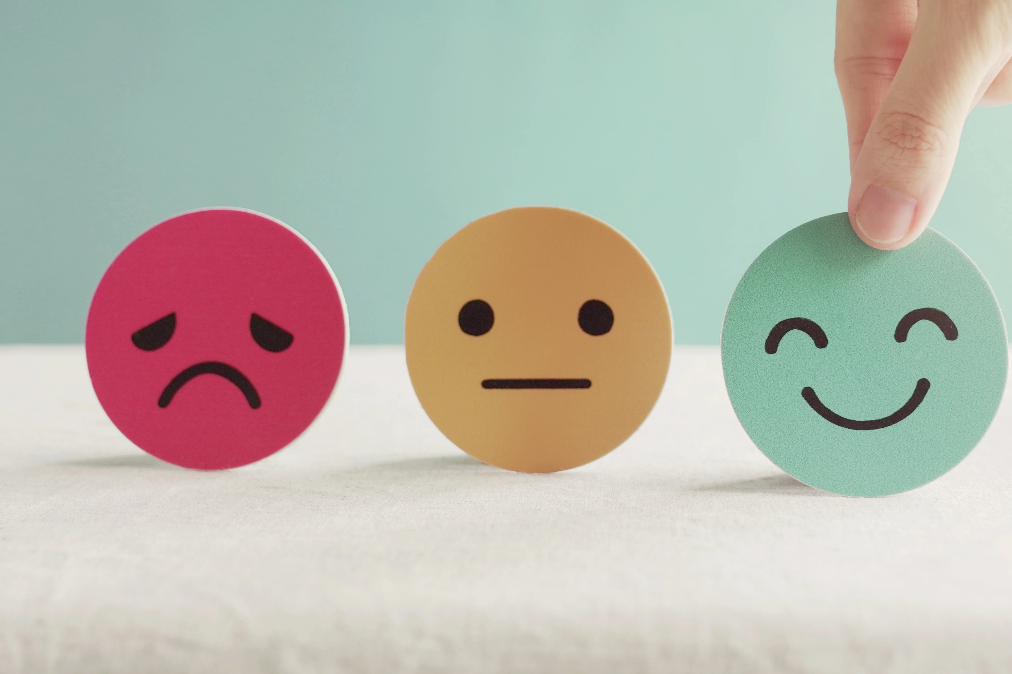 Hand choosing green happy smiley face paper cut, product, user, service feedback rating and customer reveiw, experience, satisfaction survey, psychology mental health test concept