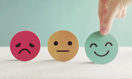 Hand choosing green happy smiley face paper cut