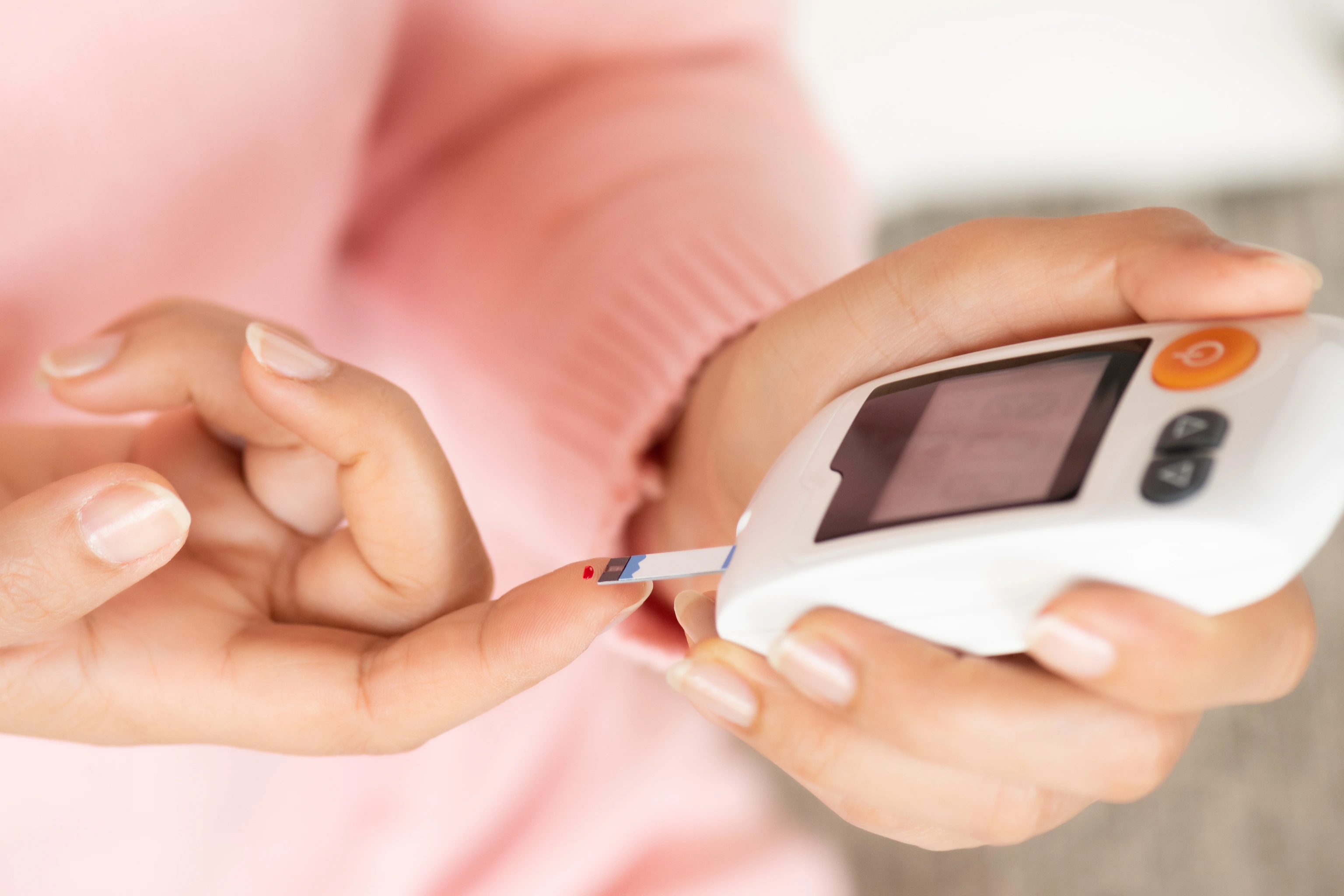 Woman checking blood sugar level