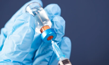 Covid-19 vaccination with vaccine bottle and syringe injection tool for coronavirus immunization treatment.