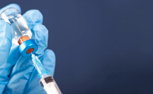 Covid-19 vaccination with vaccine bottle and syringe injection tool for coronavirus immunization treatment.