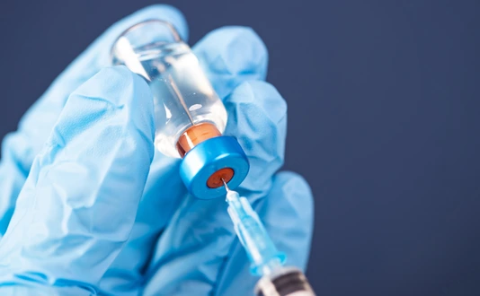 Covid-19 vaccination with vaccine bottle and syringe injection tool for coronavirus immunization treatment.