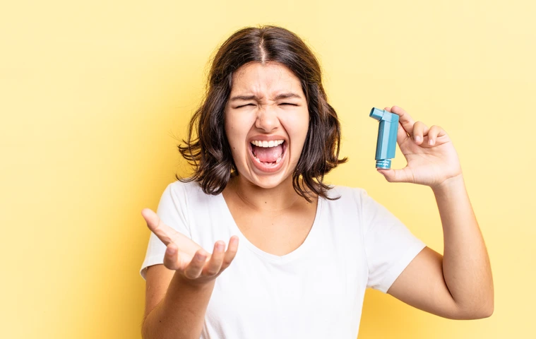 young hispanic woman looking angry, annoyed and frustrated. asthma concept