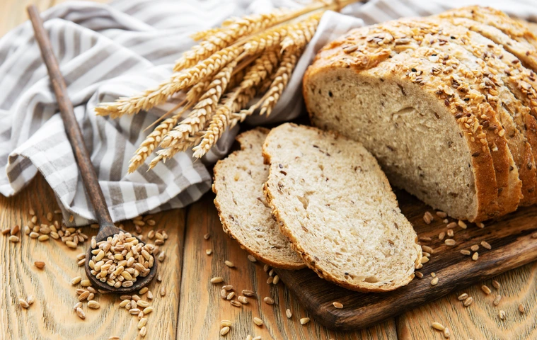 Top view of sliced wholegrain bread on a wooden table