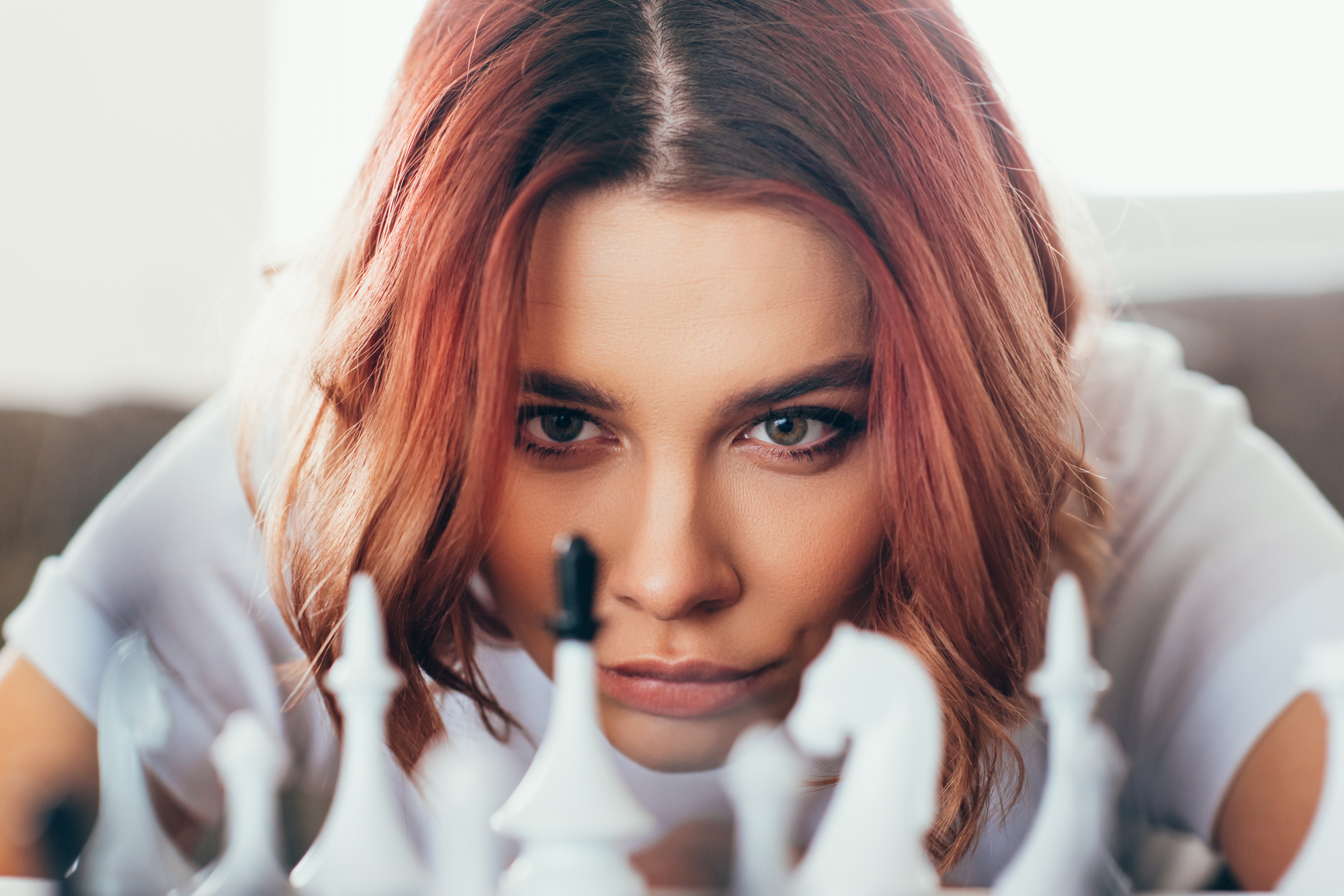 concentrated beautiful girl playing chess on self isolation, selective focus