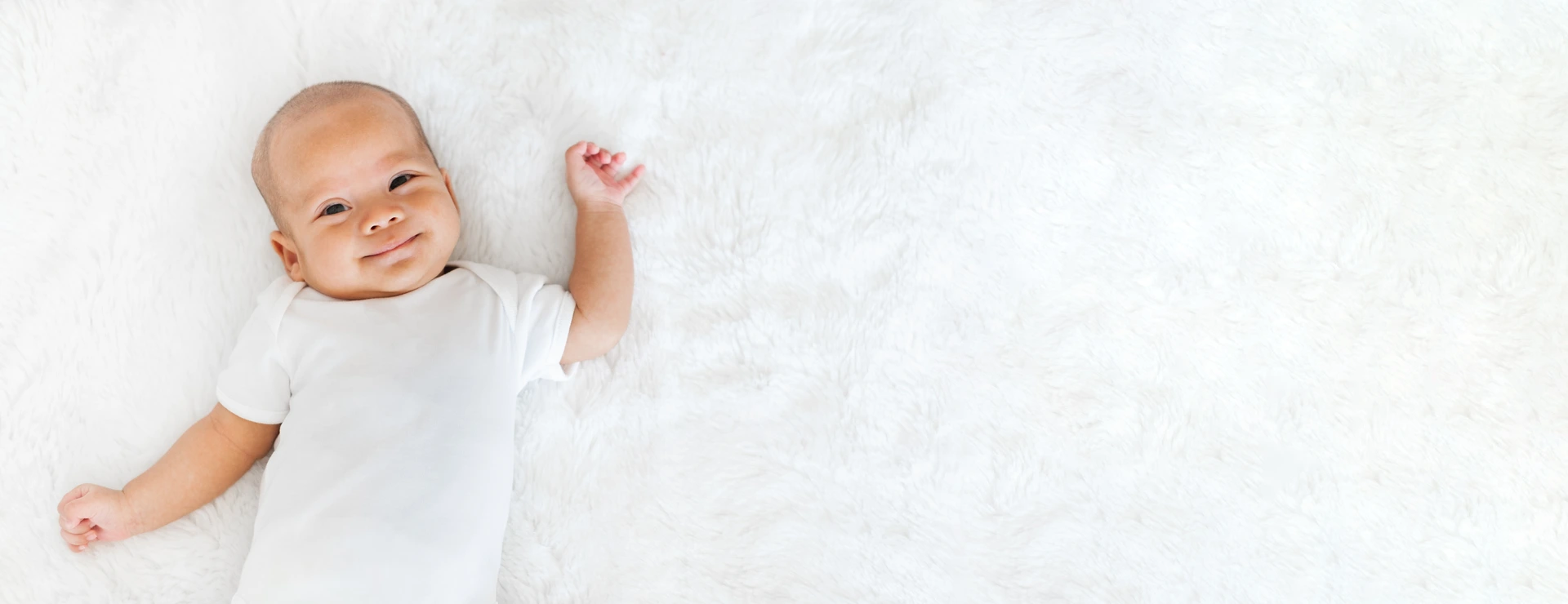 Portrait newborn baby happy over white background, topview