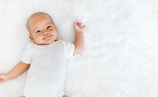 Portrait newborn baby happy over white background, topview