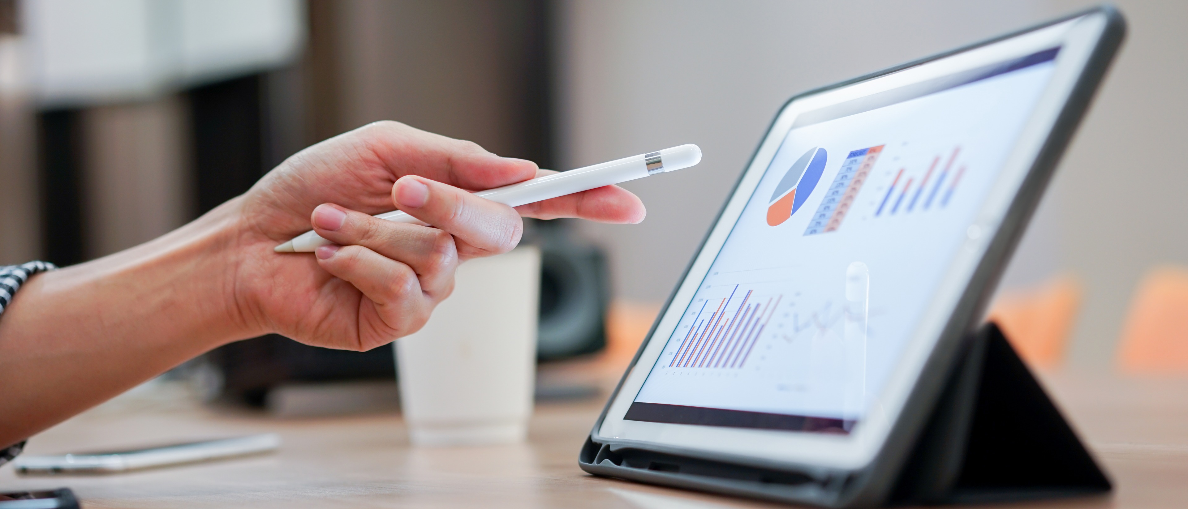 hand pointing at data on ipad