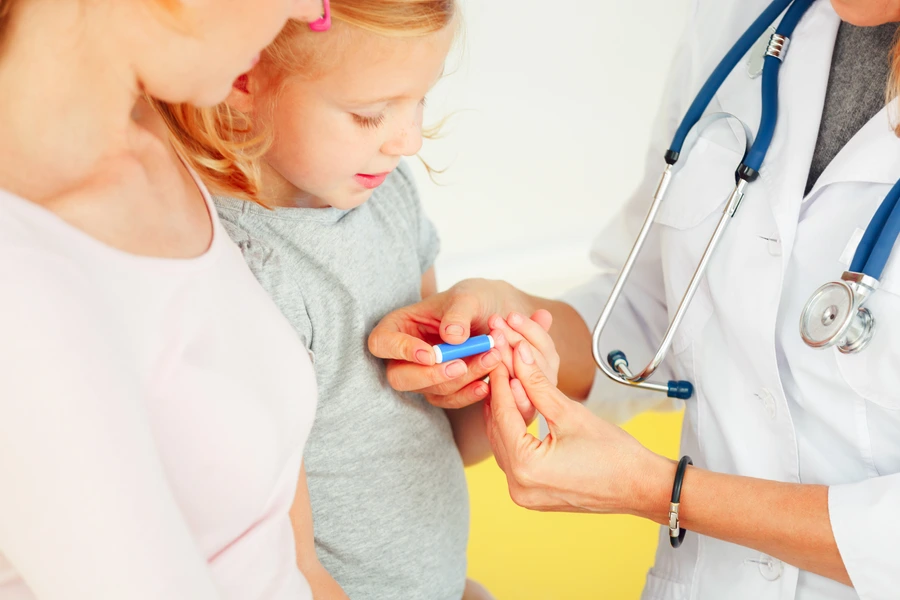Doctor taking blood test from small patient.