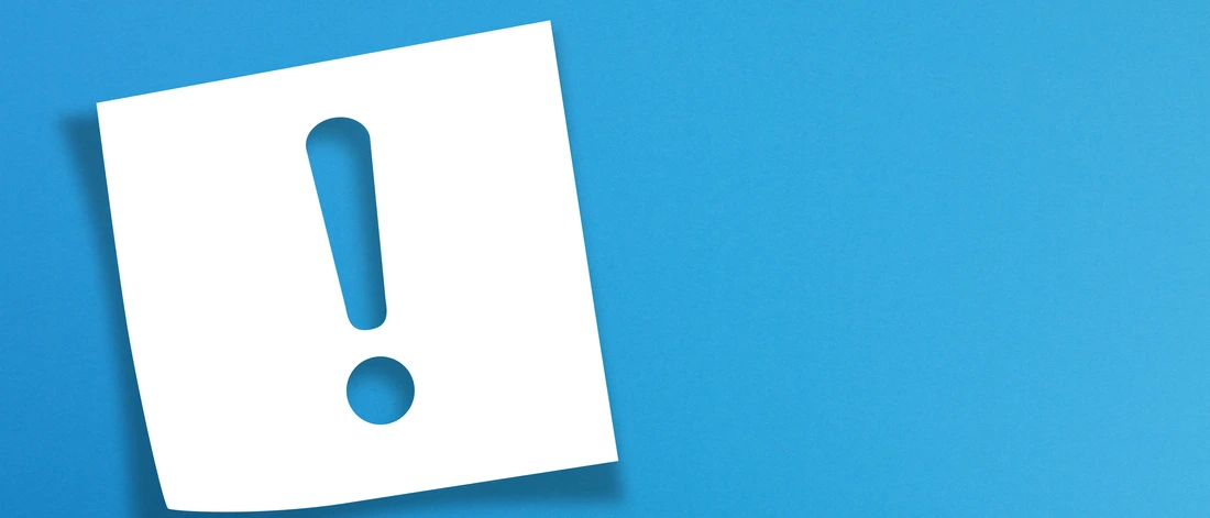 Note paper with exclamation mark on panoramic blue background