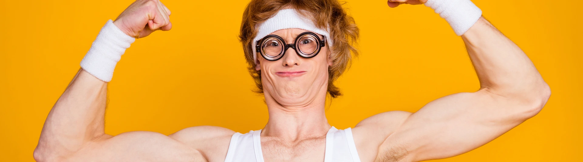 Close-up portrait of nice attractive funky content ginger foxy sportive nerd guy showing bicep endurance work out result isolated over bright vivid shine vibrant yellow color background
