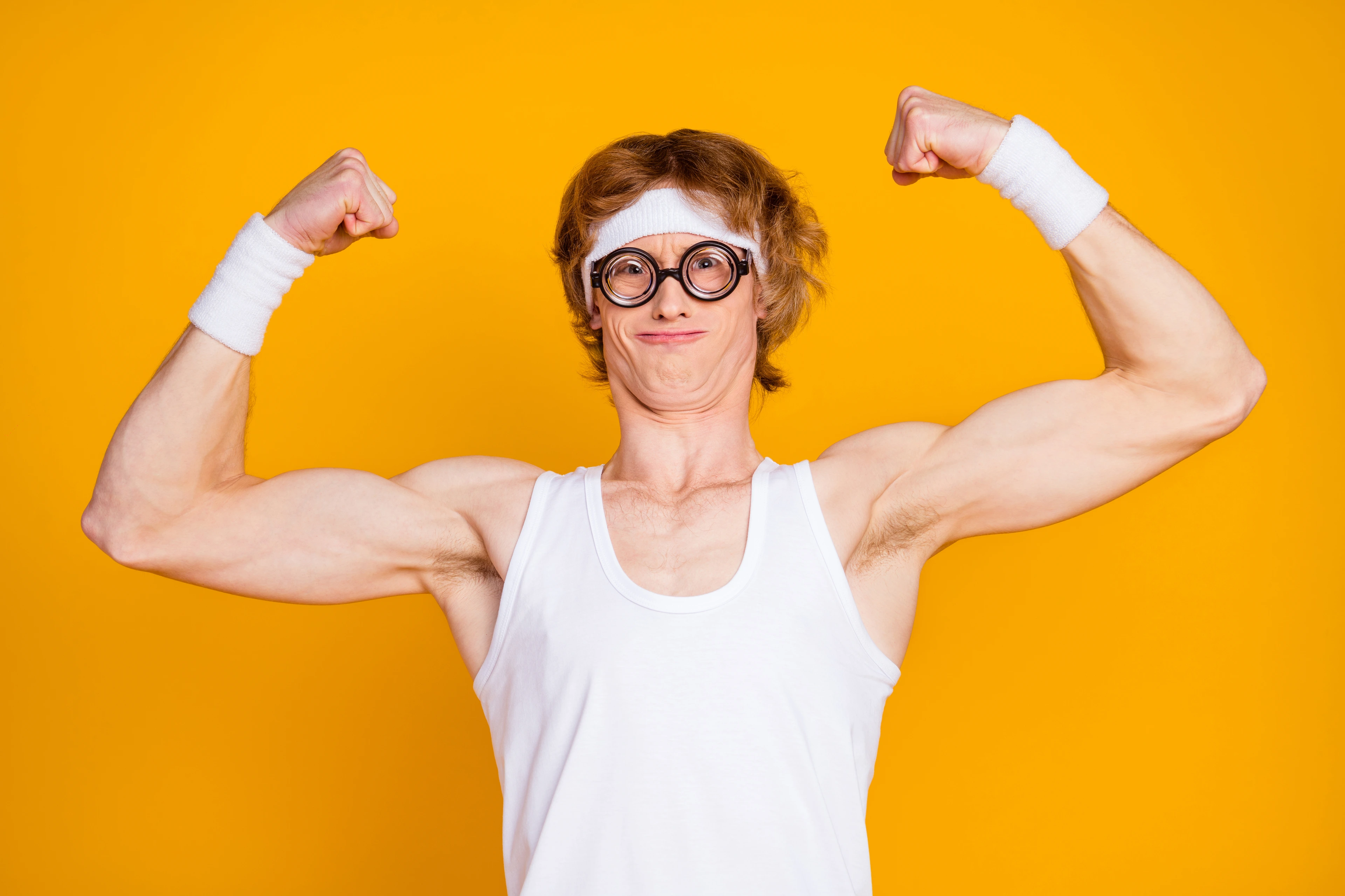 Close-up portrait of nice attractive funky content ginger foxy sportive nerd guy showing bicep endurance work out result isolated over bright vivid shine vibrant yellow color background